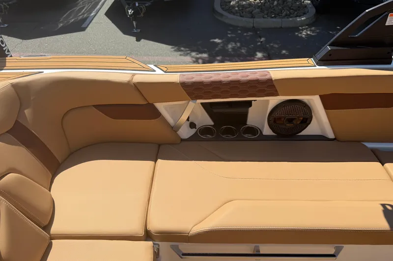 Slide: The Image of 2025 MasterCraft XT24 boat interior with tan seating and built-in speaker system. - 27