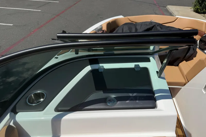 Slide: The Image of 2025 MasterCraft XT24 boat interior with tan seating and sleek dashboard design. - 30