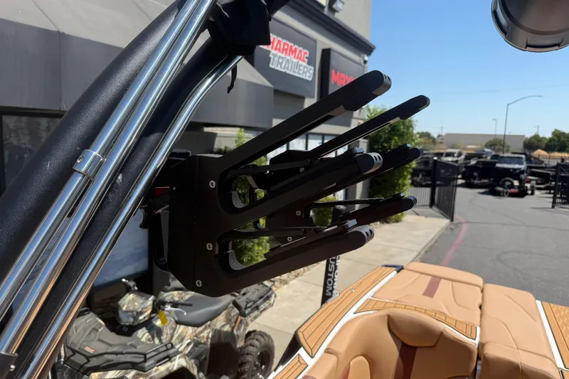 Slide: The Image of 2025 MasterCraft XT24 boat with a sleek wakeboard rack and luxurious interior. - 35