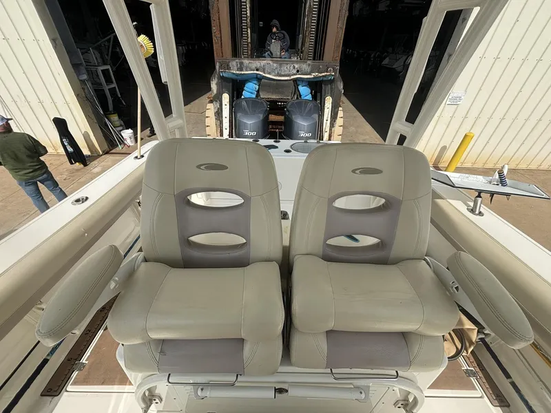 Slide: The Image of 2017 Cobia 296 Center Console boat with dual seats and visible outboard motors. - 10