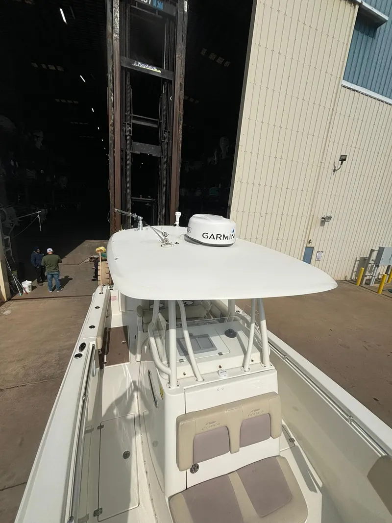 Slide: The Image of 2017 Cobia 296 Center Console boat with Garmin equipment in a marina setting. - 12