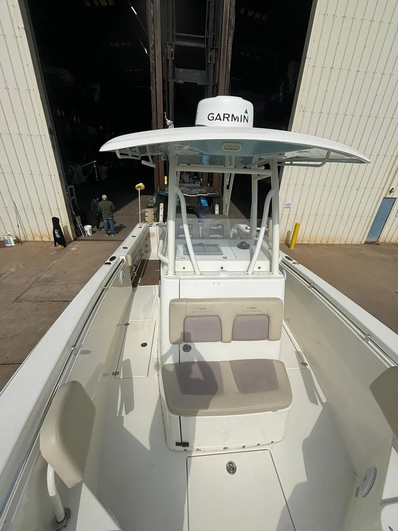 Slide: The Image of 2017 Cobia 296 Center Console boat with Garmin equipment, docked in a marina. - 14