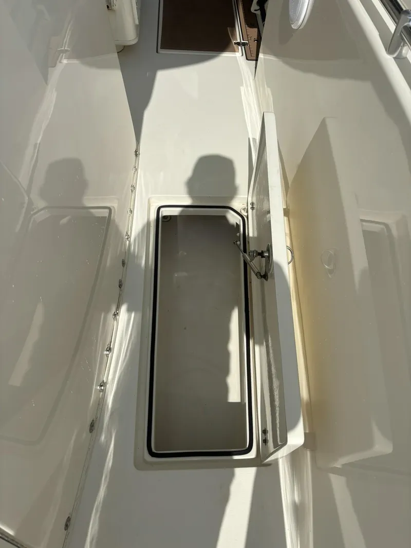 Slide: The Image of 2017 Cobia 296 Center Console boat with open storage compartment. - 20