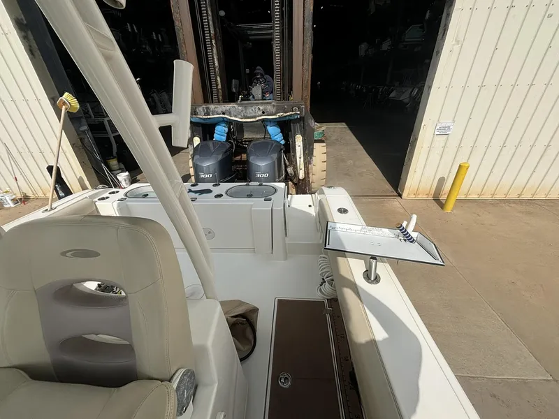 Slide: The Image of 2017 Cobia 296 Center Console boat with dual Yamaha engines in a storage facility. - 21