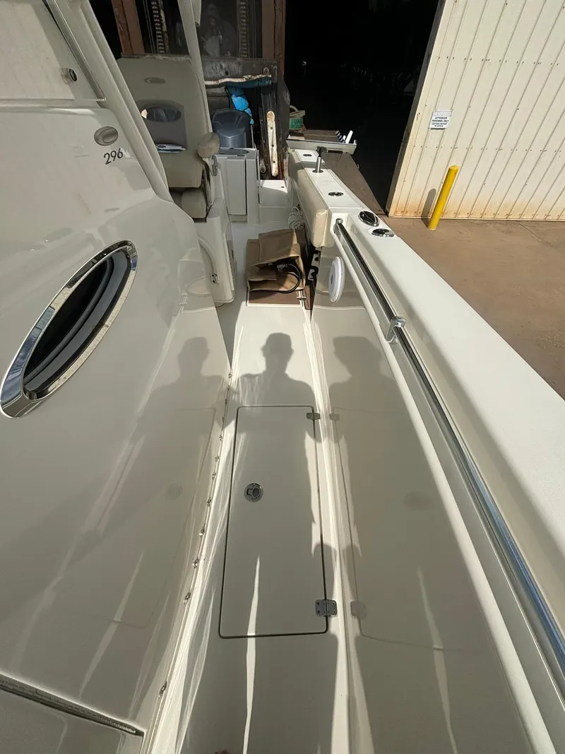 Slide: The Image of 2017 Cobia 296 Center Console boat interior with seating and storage compartments. - 24