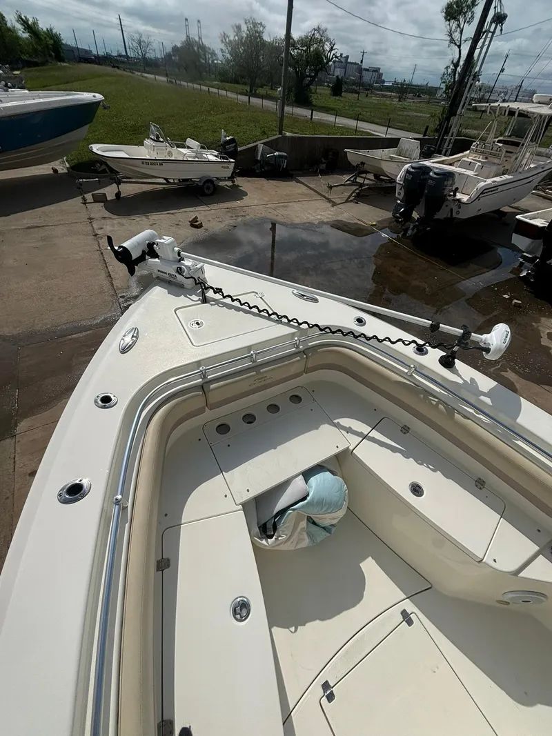 Slide: The Image of 2017 Cobia 296 Center Console boat with trolling motor on deck. - 25