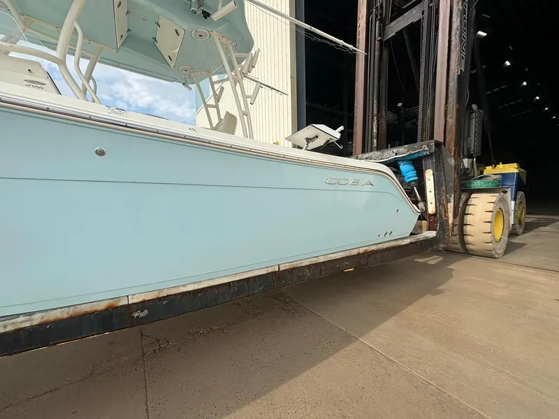 Slide: The Image of 2017 Cobia 296 Center Console boat on forklift in storage facility. - 3