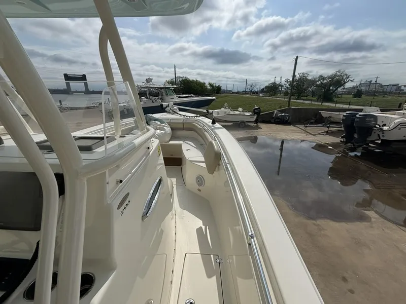 Slide: The Image of 2017 Cobia 296 Center Console boat docked, showcasing spacious deck and sleek design. - 30