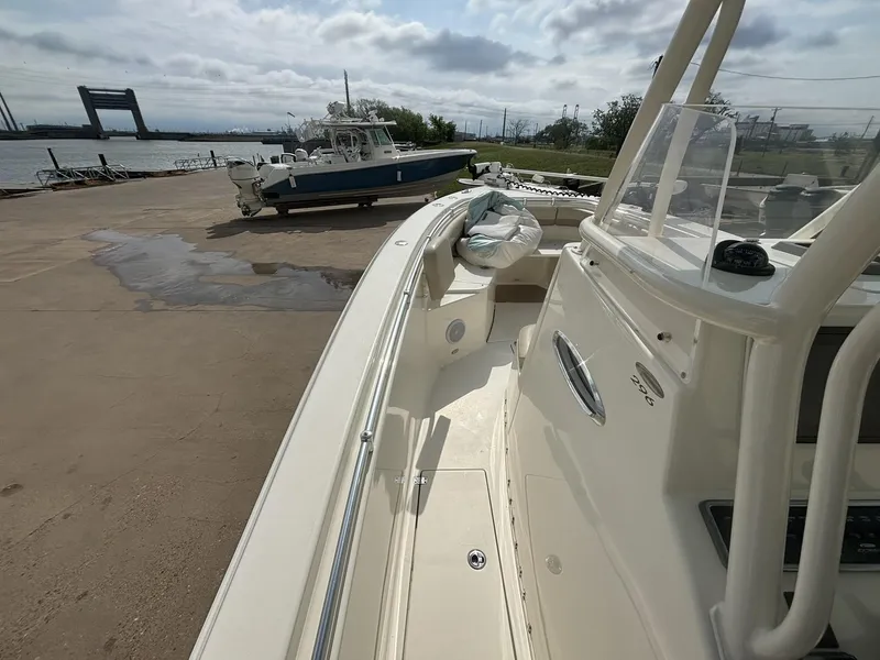 Slide: The Image of 2017 Cobia 296 Center Console boat docked near a waterfront. - 31