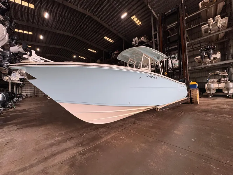 Slide: The Image of 2017 Cobia 296 Center Console boat in indoor storage facility. - 33