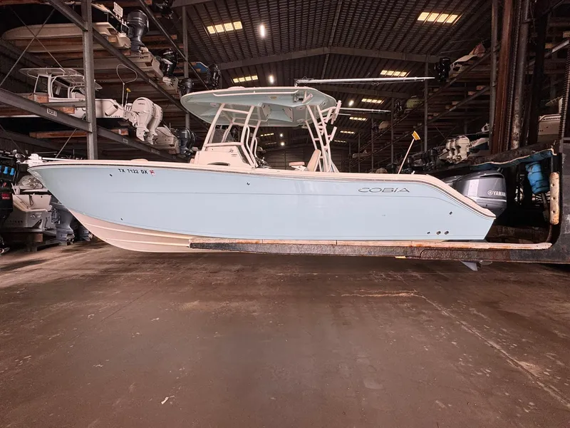 Slide: The Image of 2017 Cobia 296 Center Console boat in storage facility, side view. - 34