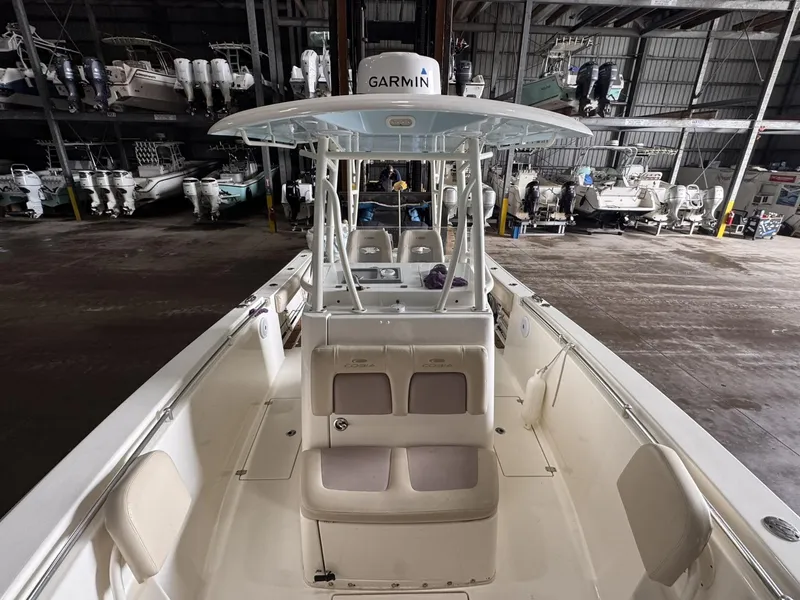 Slide: The Image of 2017 Cobia 296 Center Console boat in storage, featuring Garmin equipment. - 36