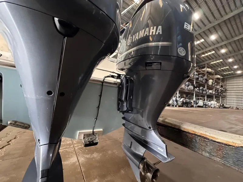 Slide: The Image of 2017 Cobia 296 Center Console with Yamaha outboard engines in a storage facility. - 37