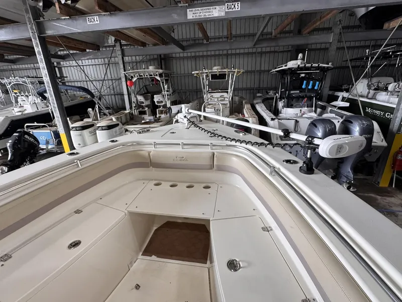 Slide: The Image of 2017 Cobia 296 Center Console boat in storage, surrounded by other vessels. - 38