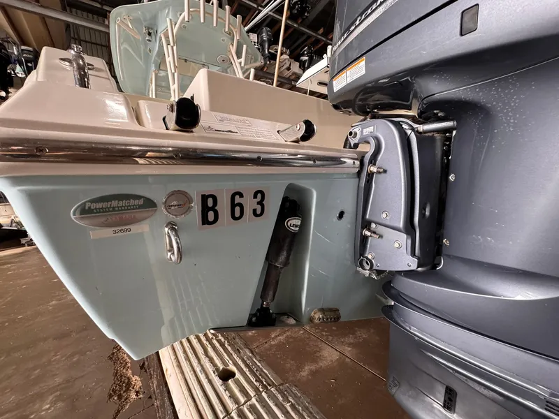 Slide: The Image of 2017 Cobia 296 Center Console boat with outboard motor in storage. - 39