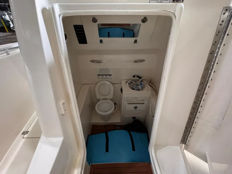 Slide: The Image of 2017 Cobia 296 Center Console boat interior with toilet and sink. - 40