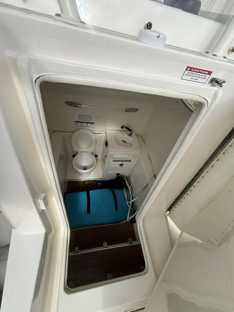 Slide: The Image of 2017 Cobia 296 Center Console boat interior with storage and equipment. - 43