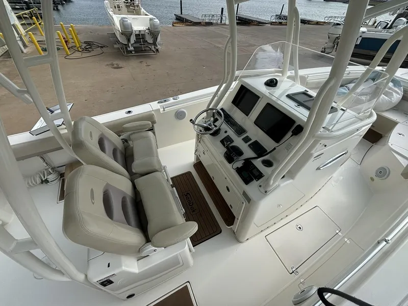 Slide: The Image of 2017 Cobia 296 Center Console boat interior with dual seats and control panel. - 5