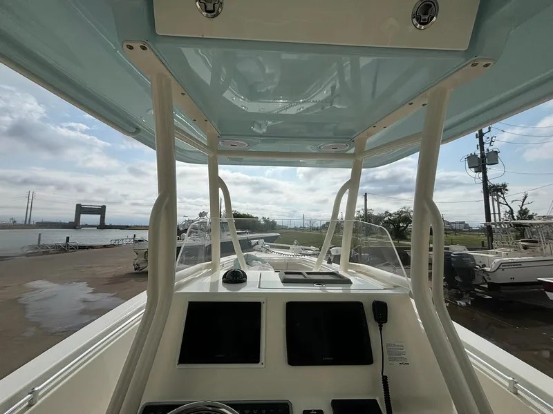 Slide: The Image of 2017 Cobia 296 Center Console boat interior with dual screens and open water view. - 6