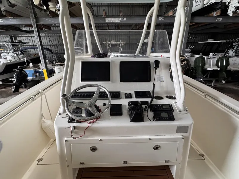 Slide: The Image of 2017 Cobia 296 Center Console boat dashboard with dual screens and steering wheel. - 8