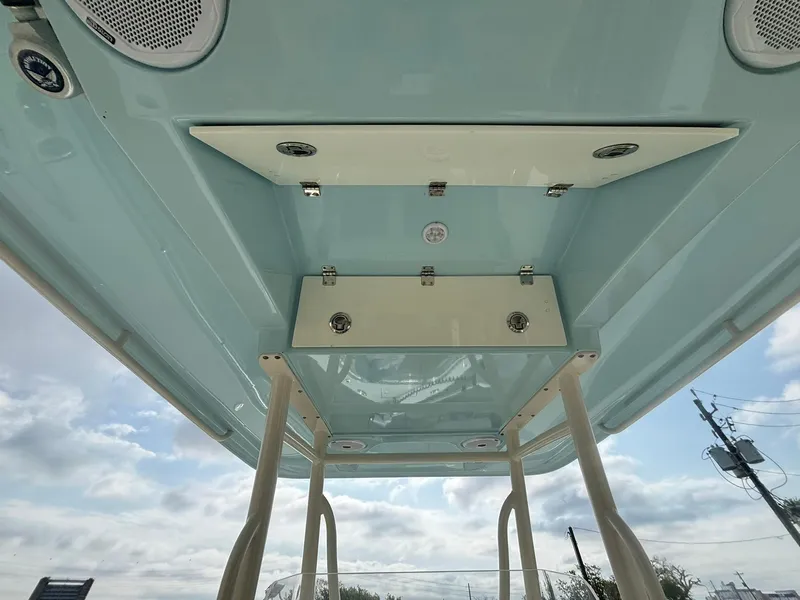 Slide: The Image of 2017 Cobia 296 Center Console boat's overhead view with speakers and storage compartments. - 9