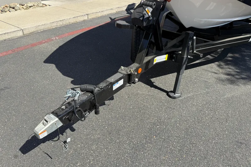 Slide: The Image of Trailer hitch of 2025 MasterCraft XT24 boat on asphalt road. - 11