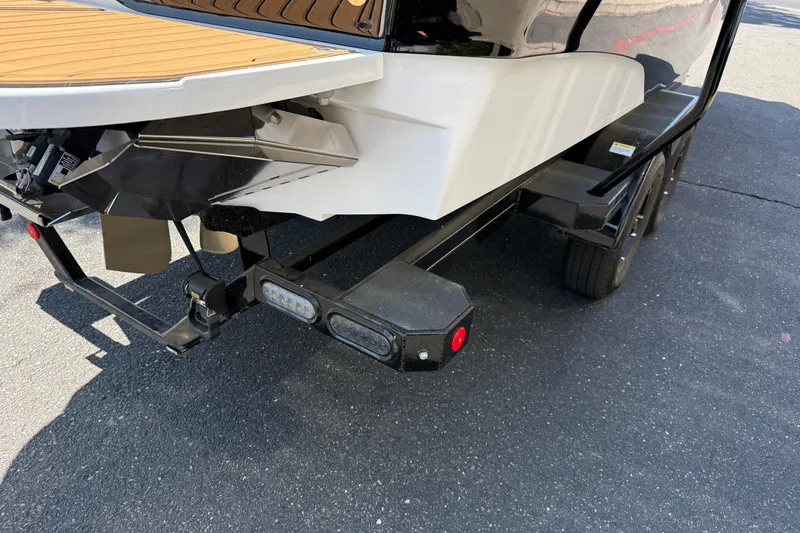 Slide: The Image of 2025 MasterCraft XT24 boat trailer with dual axles and LED lights. - 14