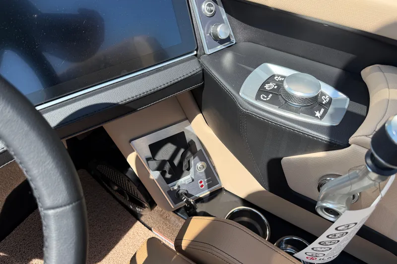 Slide: The Image of 2025 MasterCraft XT24 boat interior with control panel and steering wheel. - 18