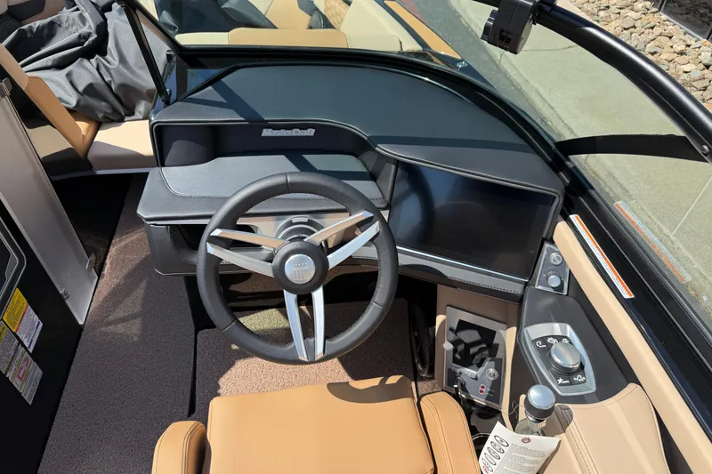 Slide: The Image of 2025 MasterCraft XT24 boat cockpit with modern steering and control panel. - 21