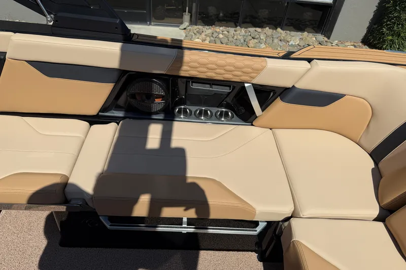 Slide: The Image of 2025 MasterCraft XT24 boat interior with tan leather seating and built-in speakers. - 25