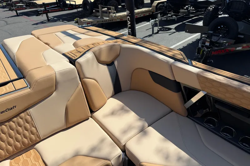 Slide: The Image of 2025 MasterCraft XT24 boat interior with luxurious tan seating and stylish design. - 28