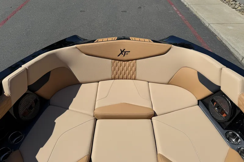 Slide: The Image of 2025 MasterCraft XT24 boat interior with beige seating and stylish design. - 35