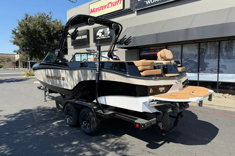 Slide: The Image of 2025 MasterCraft XT24 boat on trailer outside dealership. - 5