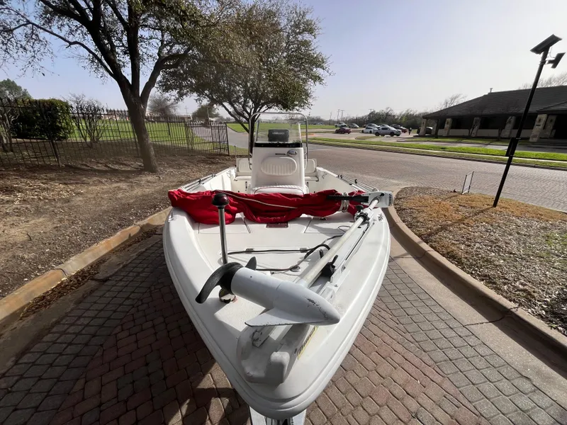 Slide: The Image of 2012 NauticStar 1810 boat parked on a paved driveway, surrounded by trees. - 17