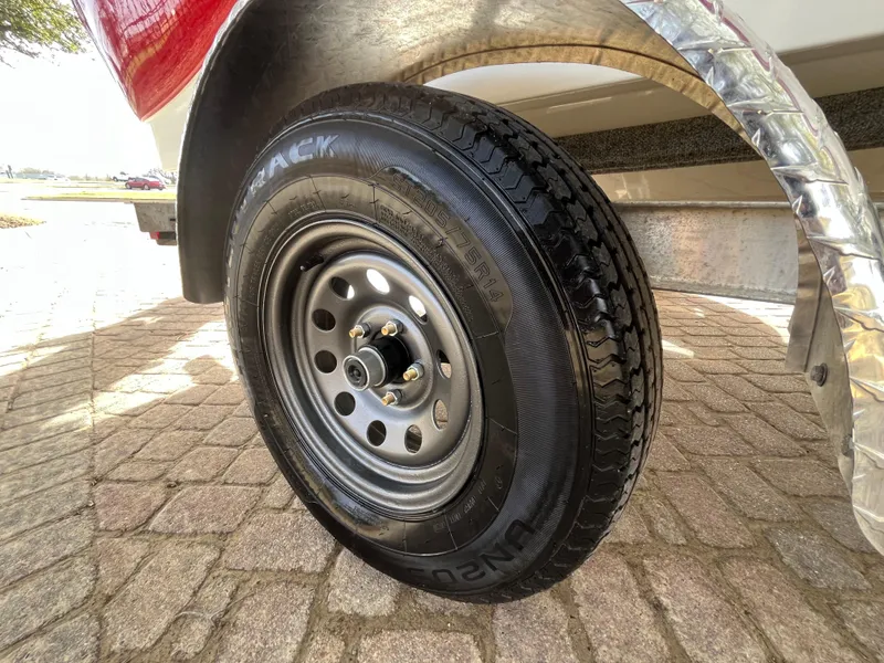 Slide: The Image of Trailer tire of a 2012 NauticStar 1810 boat on a paved surface. - 20