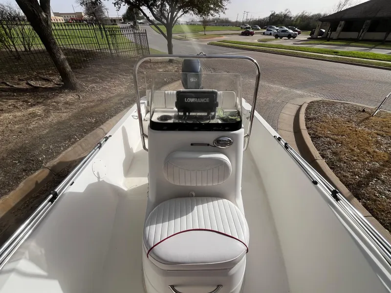 Slide: The Image of 2012 NauticStar 1810 boat interior with steering console and cushioned seat. - 22