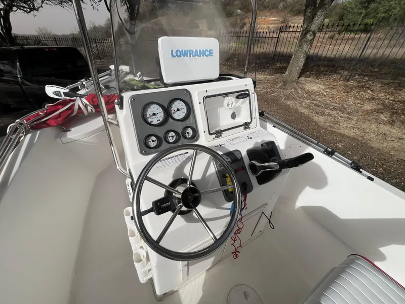 Slide: The Image of 2012 NauticStar 1810 boat console with steering wheel and Lowrance navigation system. - 25