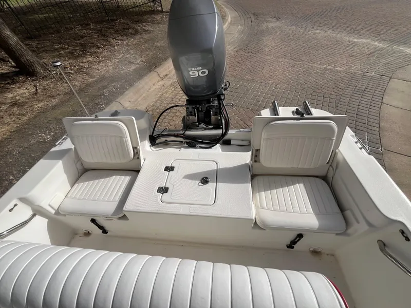 Slide: The Image of 2012 NauticStar 1810 boat interior with Yamaha 90 outboard motor, featuring white seating. - 26