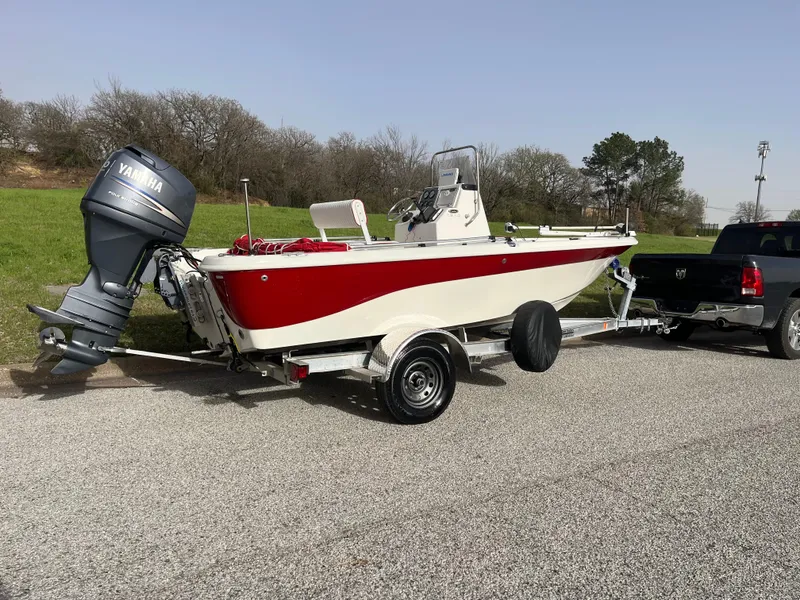 Slide: The Image of 2012 NauticStar 1810 boat with Yamaha engine on trailer, parked outdoors. - 31