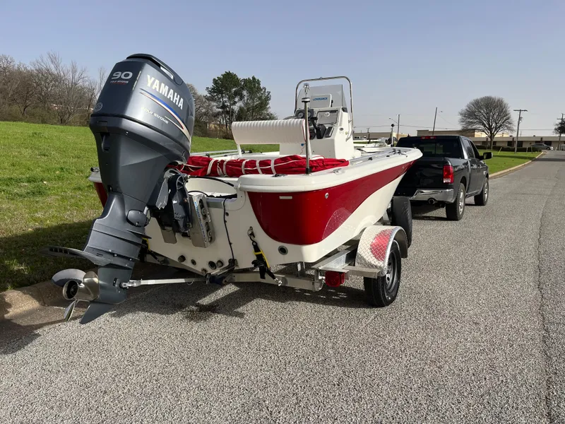Slide: The Image of 2012 NauticStar 1810 boat with Yamaha engine, hitched to a truck on a road. - 32
