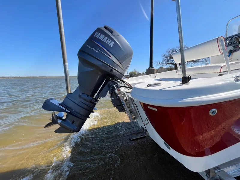 Slide: The Image of 2012 NauticStar 1810 boat with Yamaha outboard motor on a sunny day by the water. - 39