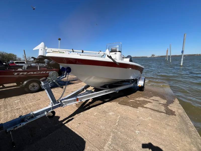 Slide: The Image of 2012 NauticStar 1810 boat on trailer by the water, clear blue sky. - 40