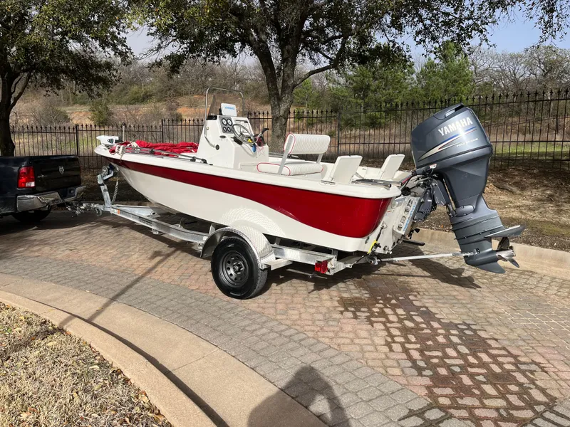 Slide: The Image of 2012 NauticStar 1810 boat with Yamaha motor on trailer, parked outdoors. - 6