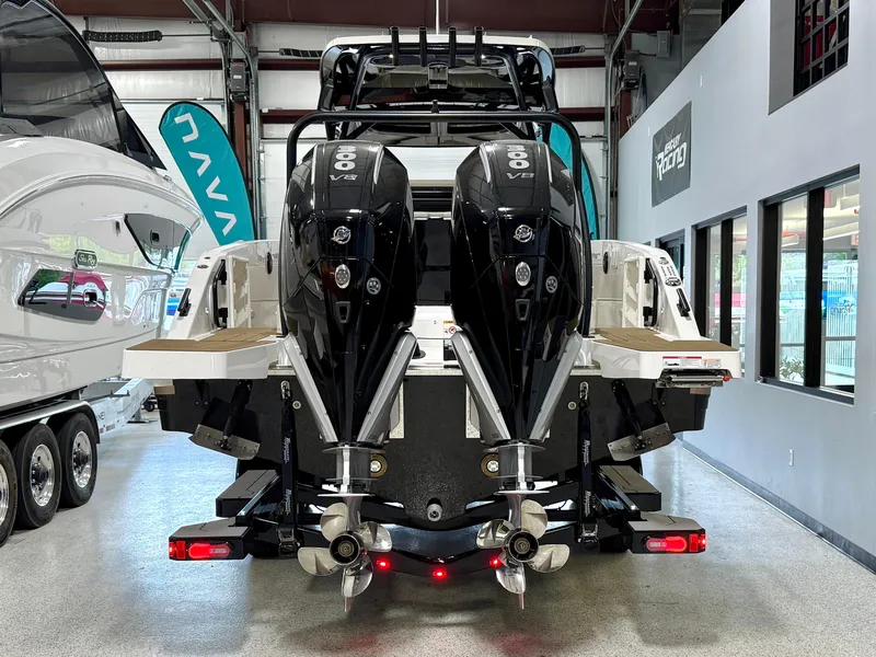 Slide: The Image of 2025 Navan S30 boat with dual outboard engines in a showroom. - 10