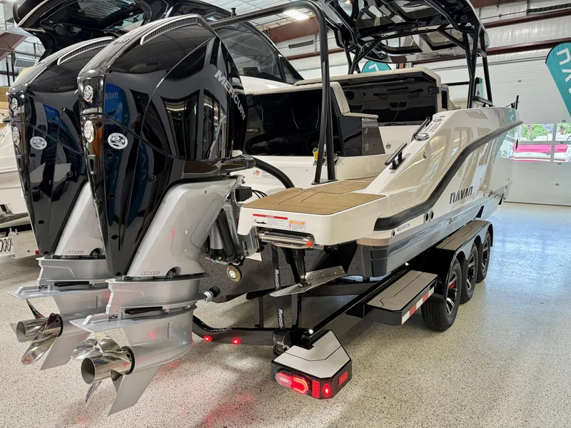 Slide: The Image of 2025 Navan S30 boat with dual engines on a trailer in a showroom. - 12