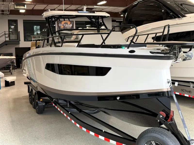 Slide: The Image of 2025 Navan S30 boat on trailer in showroom, sleek design, modern features. - 15