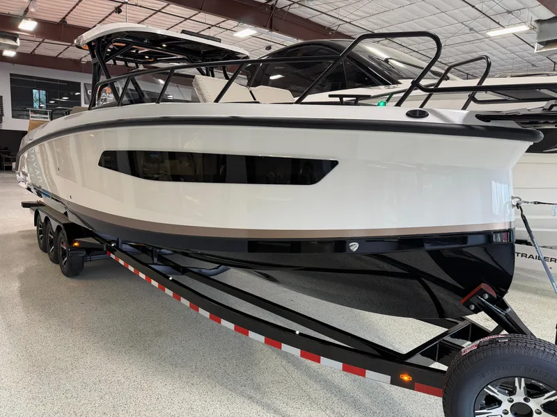 Slide: The Image of Navan S30 2025 boat on trailer in showroom, sleek design, modern features. - 2