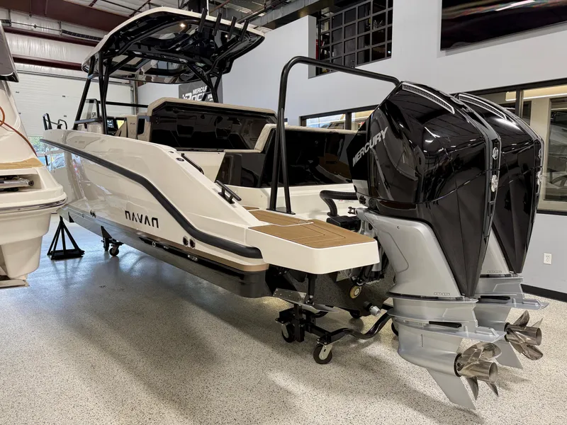 Slide: The Image of Navan S30 2025 boat with dual Mercury outboard engines in showroom. - 21