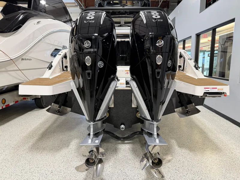 Slide: The Image of Navan S30 2025 boat with dual outboard engines in showroom. - 22