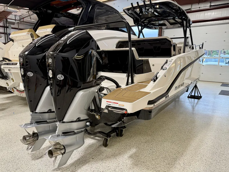 Slide: The Image of Navan S30 2025 boat with dual outboard engines in a showroom setting. - 23